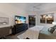 Serene bedroom featuring a flat-screen TV and a view of the backyard through the sliding glass door at 9408 Glen Abbey Ln, Sarasota, FL 34238