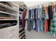 Organized closet with shelves, drawers, and rods for efficient storage and display of clothing and accessories at 9408 Glen Abbey Ln, Sarasota, FL 34238