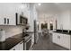 Modern kitchen with sleek appliances, white cabinetry, and an attached dining area at 9408 Glen Abbey Ln, Sarasota, FL 34238