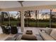 Outdoor lanai featuring comfortable seating and a view of the golf course at sunset at 9408 Glen Abbey Ln, Sarasota, FL 34238