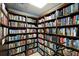 Cozy community library with floor-to-ceiling bookshelves filled with a diverse collection of books at 9408 Glen Abbey Ln, Sarasota, FL 34238