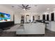 Bright, open living room featuring modern decor, a ceiling fan, and dark wood-look flooring at 9408 Glen Abbey Ln, Sarasota, FL 34238