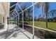 The spacious, screened-in lanai is perfect for relaxing and enjoying the beautiful scenery at 9408 Glen Abbey Ln, Sarasota, FL 34238