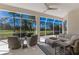 Enclosed patio featuring comfortable seating and scenic views of the surrounding landscape at 9408 Glen Abbey Ln, Sarasota, FL 34238