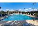 Community pool with lounge chairs and umbrellas, perfect for relaxation and recreation at 9408 Glen Abbey Ln, Sarasota, FL 34238
