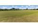 Well-maintained putting green with flags on a sunny day, ready for practice and play at 9408 Glen Abbey Ln, Sarasota, FL 34238