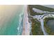 Beautiful aerial view of beach with tranquil waters, showcasing the desirable coastal location at 9928 Bright Water Dr, Englewood, FL 34223