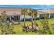 A well-manicured backyard boasts a screened lanai and neat landscaping, perfect for outdoor enjoyment at 9928 Bright Water Dr, Englewood, FL 34223