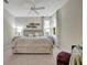 A serene bedroom features a rustic wood bed, soft patterned bedding, and stylish lamps on matching nightstands at 9928 Bright Water Dr, Englewood, FL 34223