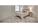 Cozy bedroom with a plush floral rug, bed with stylish headboard, and matching nightstands and lamps at 9928 Bright Water Dr, Englewood, FL 34223