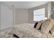 Comfortable bedroom features a bright window, plush bedding, and ample closet space at 9928 Bright Water Dr, Englewood, FL 34223