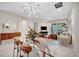 Dining area with glass table, modern lighting, and flow into a bright, inviting living space at 9928 Bright Water Dr, Englewood, FL 34223