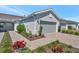 Charming home exterior with a well-manicured lawn and a two-car garage, offering great curb appeal at 9928 Bright Water Dr, Englewood, FL 34223