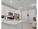 Bright kitchen featuring a large island with white countertop and modern stainless steel appliances at 9928 Bright Water Dr, Englewood, FL 34223