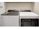 Modern laundry room with a front load washer and dryer, offering convenience and efficiency at 9928 Bright Water Dr, Englewood, FL 34223