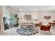 A cozy living area with modern furnishings and a sliding glass door provides access to the outdoors at 9928 Bright Water Dr, Englewood, FL 34223