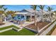 Open-air dining at a community restaurant featuring blue umbrellas and landscaping at 9928 Bright Water Dr, Englewood, FL 34223