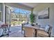 Outdoor patio with a dining area and grill, perfect for entertaining guests or enjoying meals at 9928 Bright Water Dr, Englewood, FL 34223