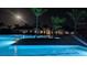 Community pool at night with clubhouse in the background at 9928 Bright Water Dr, Englewood, FL 34223