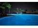 Community pool view at night with waterfall feature at 9928 Bright Water Dr, Englewood, FL 34223