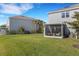 Spacious backyard showcasing a covered patio and manicured lawn between homes at 8612 Lunar Skye St, Sarasota, FL 34241