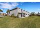 Well-maintained backyard with manicured lawn, patio, and tasteful landscaping between homes at 8612 Lunar Skye St, Sarasota, FL 34241