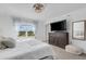 Bedroom with a large window and view, complete with a TV and comfortable seating at 8612 Lunar Skye St, Sarasota, FL 34241