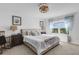 Bright bedroom with decorative chandelier, plush carpet, and large window with water view at 8612 Lunar Skye St, Sarasota, FL 34241