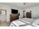 Relaxing bedroom with en-suite bathroom, large TV, and ample storage at 8612 Lunar Skye St, Sarasota, FL 34241