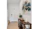 Inviting foyer with a console table, modern art, and tile flooring at 8612 Lunar Skye St, Sarasota, FL 34241