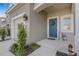 Beautiful front exterior featuring a blue door with wreath, and attached garage at 8612 Lunar Skye St, Sarasota, FL 34241