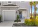 Charming home exterior with a blue front door, attached garage, and well-maintained landscaping at 8612 Lunar Skye St, Sarasota, FL 34241