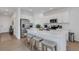 Spacious kitchen featuring a large island with seating, stainless steel appliances, and modern finishes at 8612 Lunar Skye St, Sarasota, FL 34241
