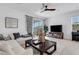 Comfortable living room with tile flooring and sliding glass door to backyard at 8612 Lunar Skye St, Sarasota, FL 34241