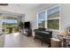 Bright living room with tile flooring, and a sliding glass door to a screened lanai at 8612 Lunar Skye St, Sarasota, FL 34241