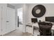 A bright office space features a large clock, desk, and access to the bedroom at 8612 Lunar Skye St, Sarasota, FL 34241