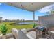 Inviting covered patio with comfortable seating and a view of the pond at 8612 Lunar Skye St, Sarasota, FL 34241