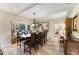 Light filled formal dining room with a large window and a view of the backyard at 1011 Cimarron Nw Cir, Bradenton, FL 34209