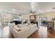 Bright living room featuring hardwood floors, a fireplace, ceiling fans, and access to the lanai at 1011 Cimarron Nw Cir, Bradenton, FL 34209