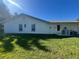 Spacious backyard featuring a well-maintained lawn and the rear side of the house at 10522 Green Meadow Ln, Port Richey, FL 34668