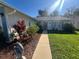 Inviting front exterior with lush landscaping and a walkway leading to the front door at 10522 Green Meadow Ln, Port Richey, FL 34668