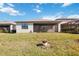 Spacious backyard featuring a screened lanai and lush green grass, perfect for outdoor enjoyment at 11165 Balfour St, Venice, FL 34293