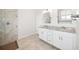 Bathroom featuring double vanity sinks, granite countertops, tiled floors, and shower at 11165 Balfour St, Venice, FL 34293