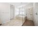Bathroom featuring a tub with window, tiled floors, and a walk-in shower at 11165 Balfour St, Venice, FL 34293