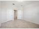 Spacious bedroom showcasing neutral tile floors, white walls and trim, and multiple doors for a simple design at 11165 Balfour St, Venice, FL 34293