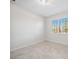 Well-lit bedroom showcasing neutral tile floors, white walls and trim, and plantation shutters for a bright design at 11165 Balfour St, Venice, FL 34293