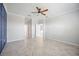 This bedroom features tiled flooring, a ceiling fan, and neutral paint tones at 11165 Balfour St, Venice, FL 34293