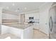 Bright kitchen featuring white cabinets, granite countertops, and stainless steel appliances at 11165 Balfour St, Venice, FL 34293