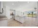 Open kitchen with white cabinets, granite countertops, stainless steel appliances, and an island at 11165 Balfour St, Venice, FL 34293