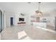 Open-concept living room featuring tile floors, modern lighting, and an accent wall at 11165 Balfour St, Venice, FL 34293